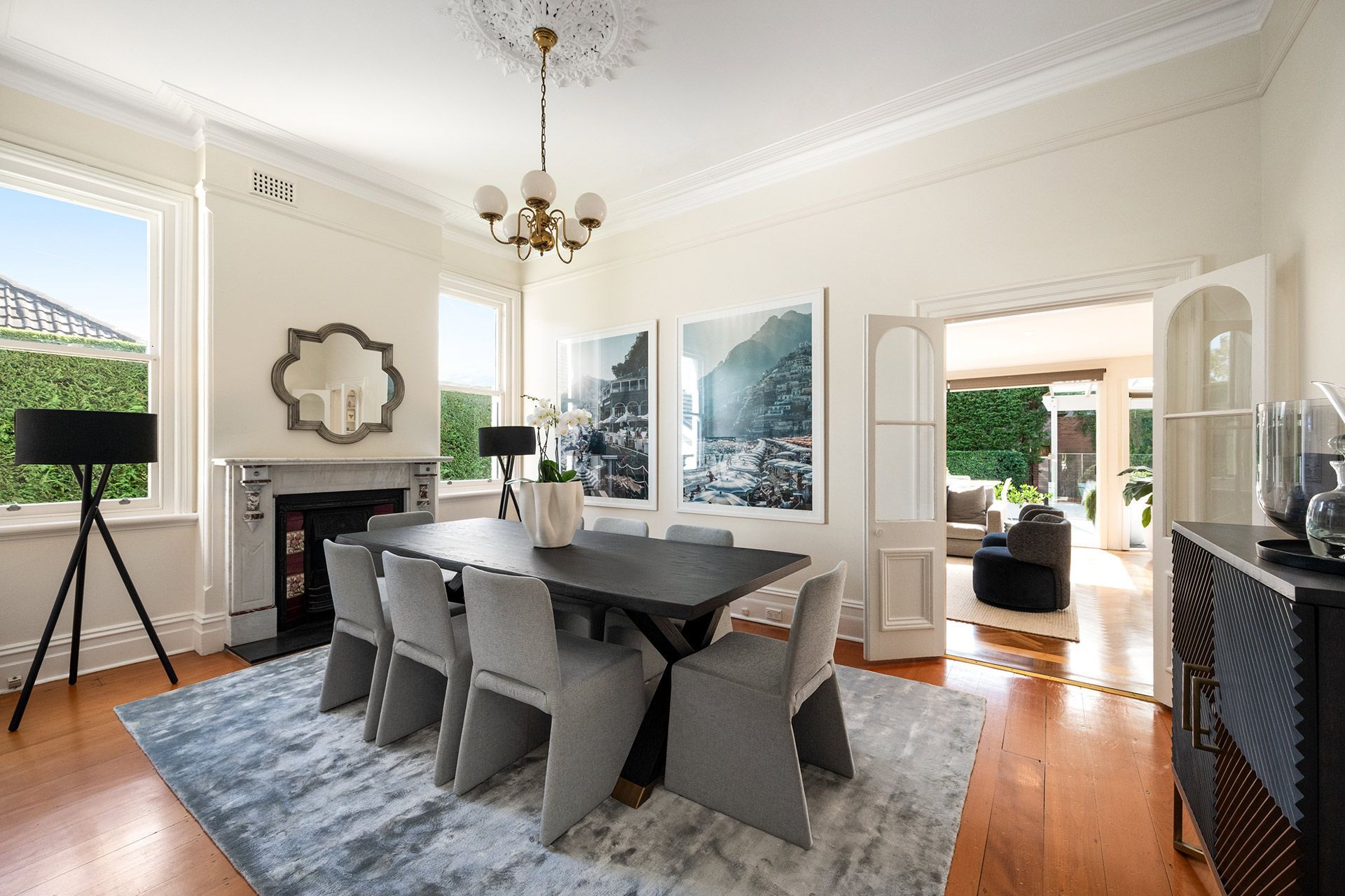 A dining room with a table and chairs and a fireplace.