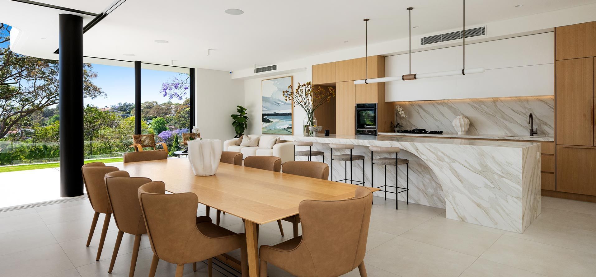 There is a dining table and chairs in the middle of the room.