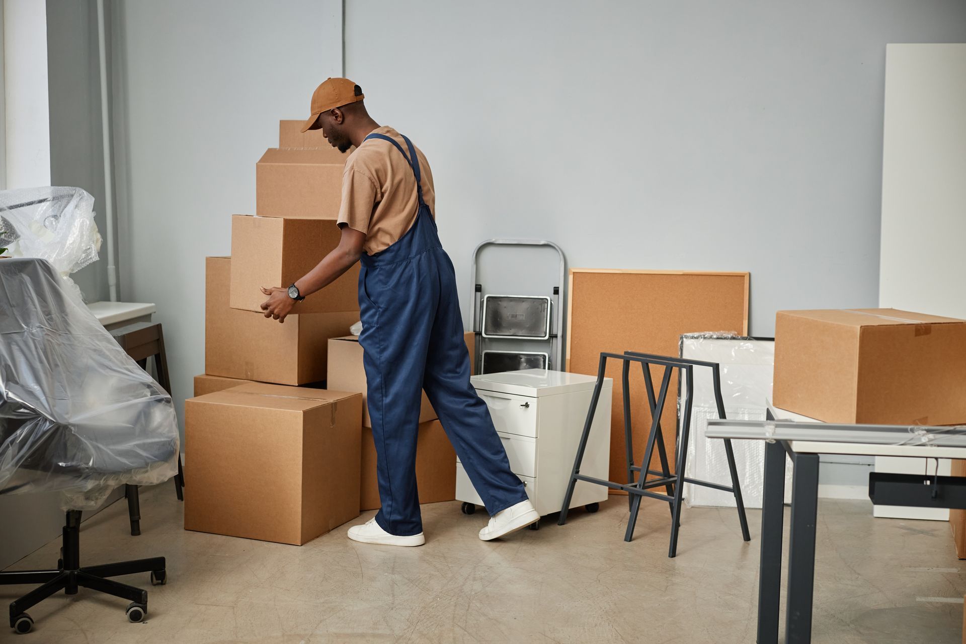 A man is moving boxes in an office.