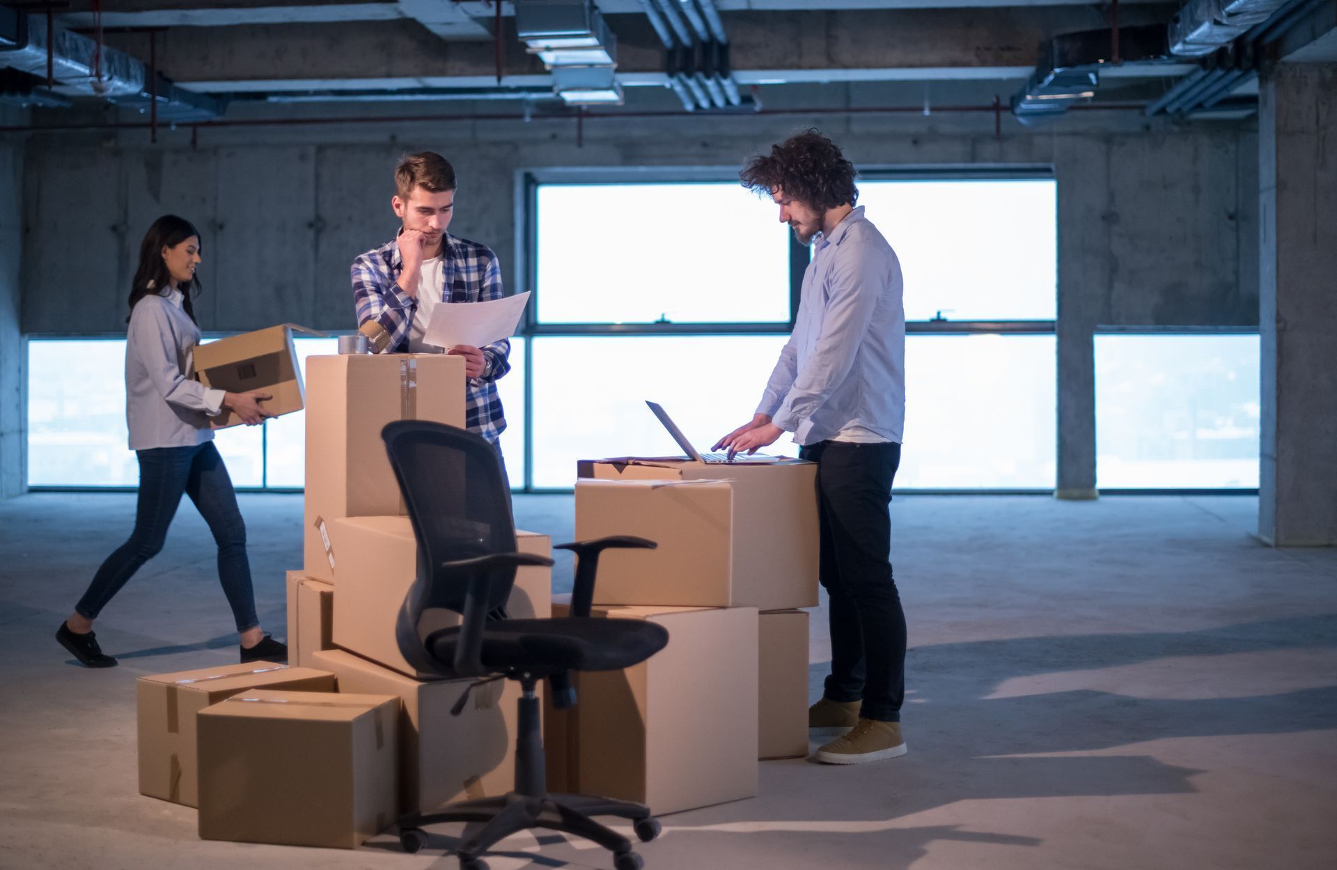 A group of people are moving into a new office.