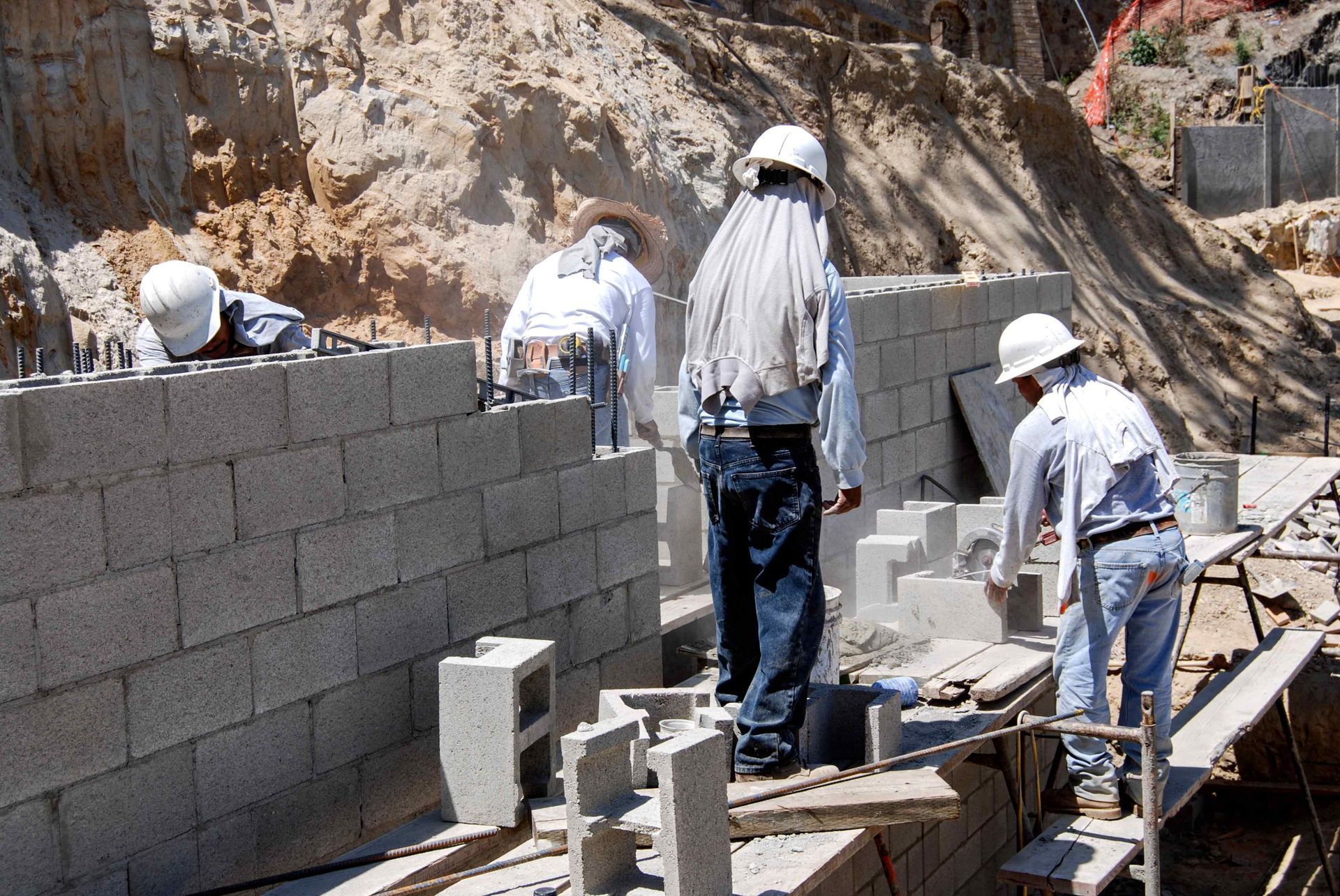 Mountain Landscapers crafting a large retaining wall