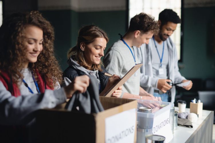 Volunteers sorting donations into boxes at a donation center.