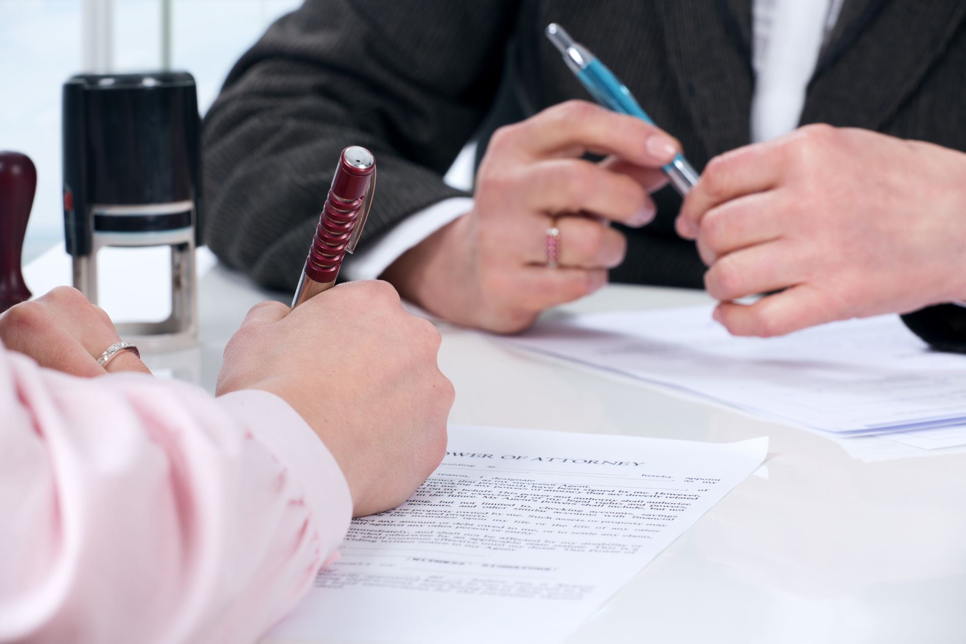 Estate planner and client signing papers