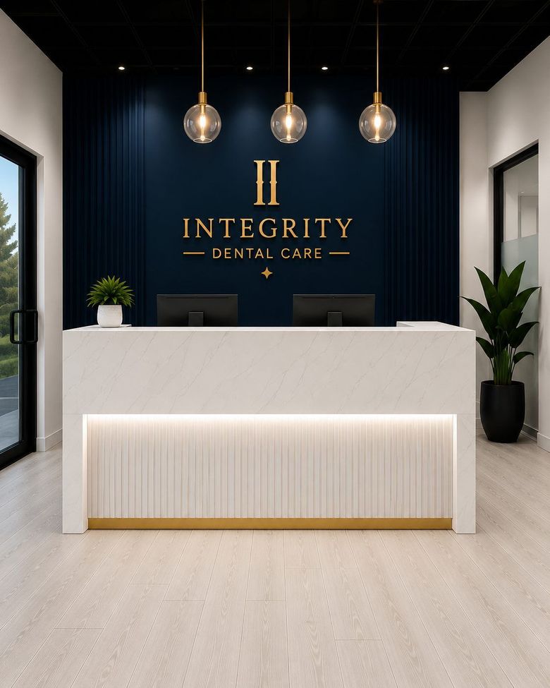 Modern reception desk in a sleek lobby with dark blue wall, gold logo, and hanging pendant lights.