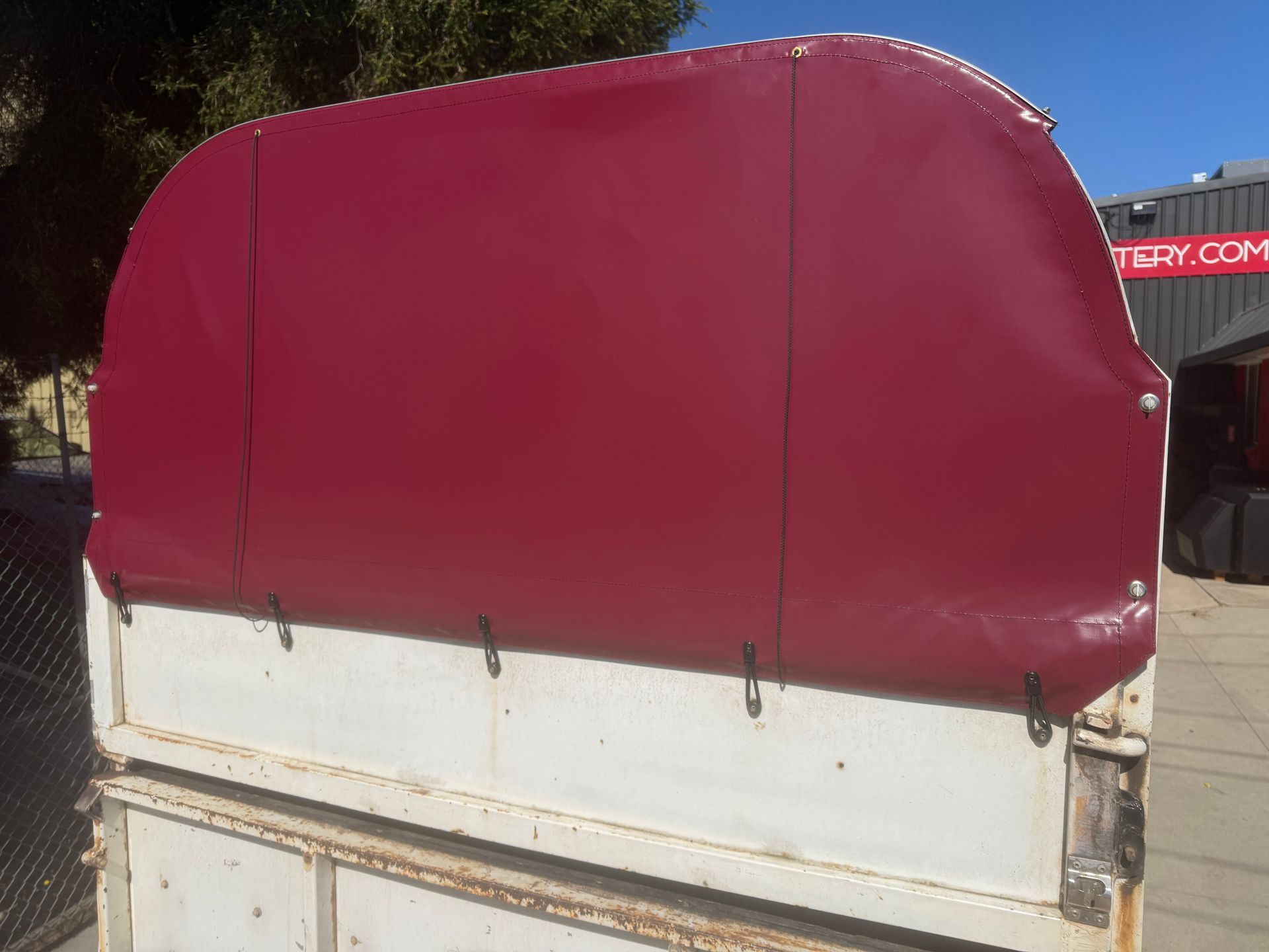 Horse float rear cover in burgundy PVC with press studs and bunjis