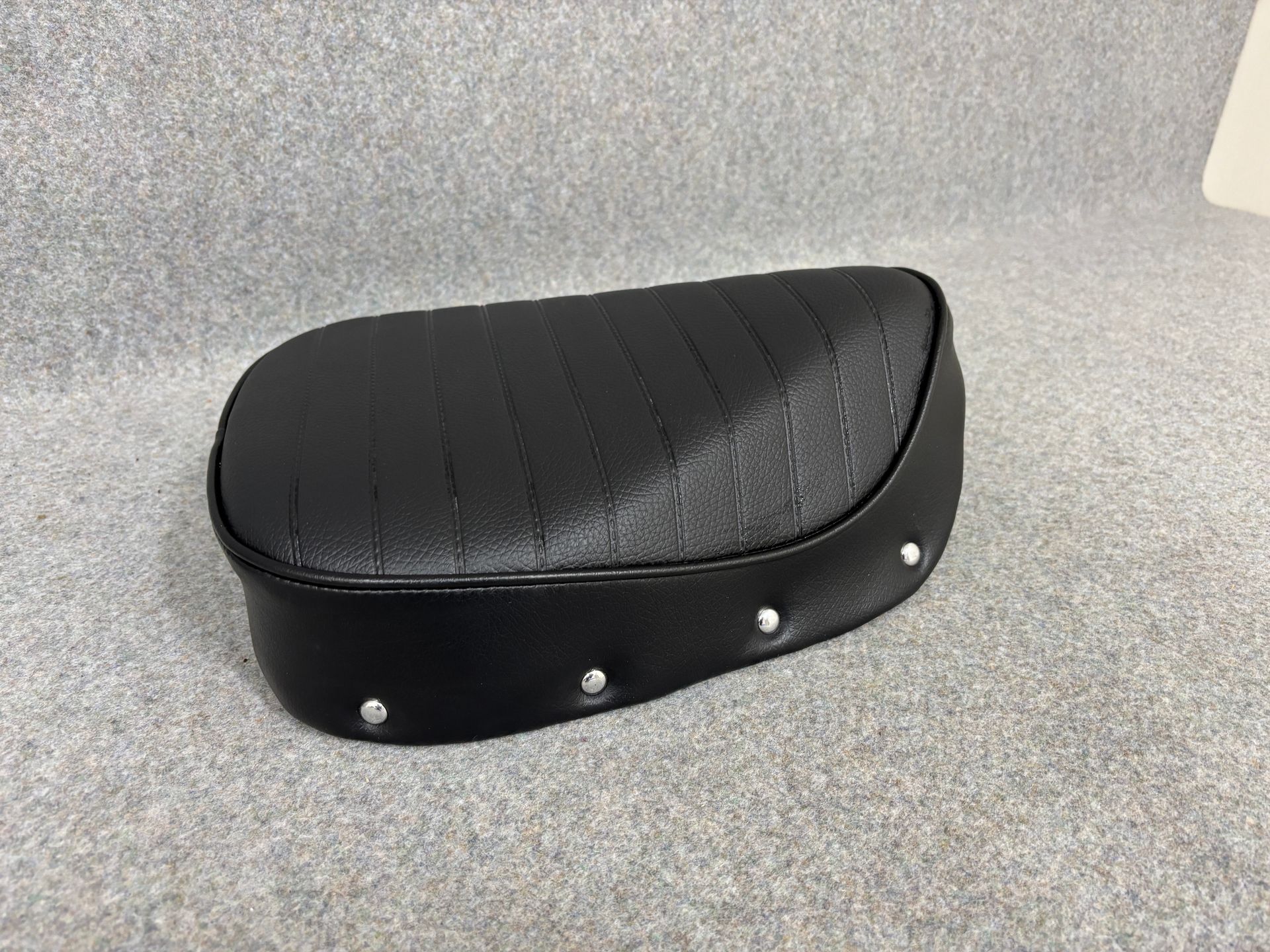 Postie bike seat cover in black vinyl with waterproof welded pleats