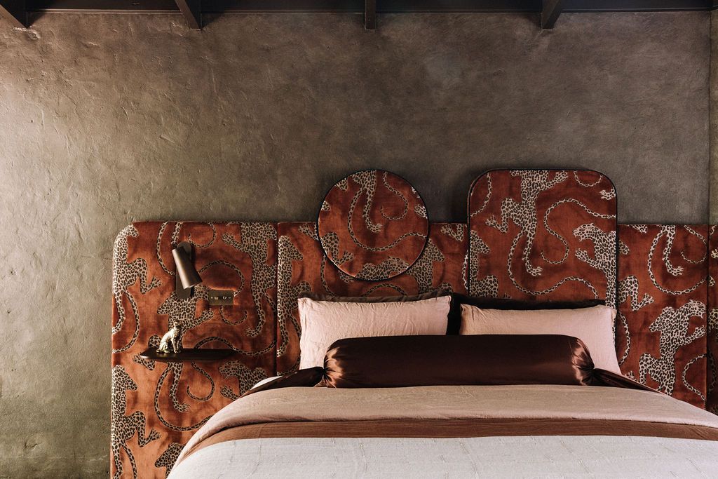 Bed head upholstered in Catherine Martin x Mokum Panthera fabric