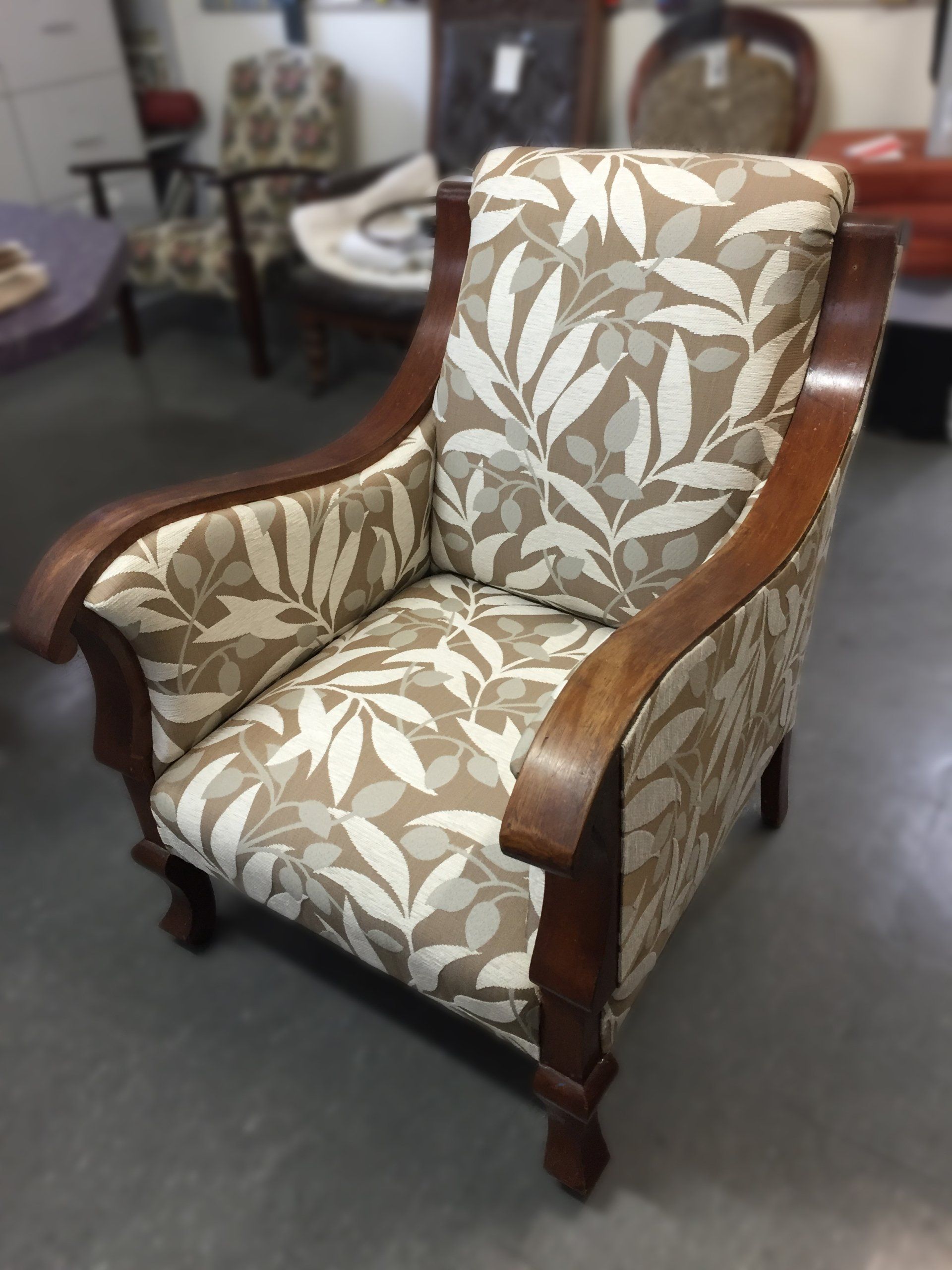 Antique single lounge chair with timber trim