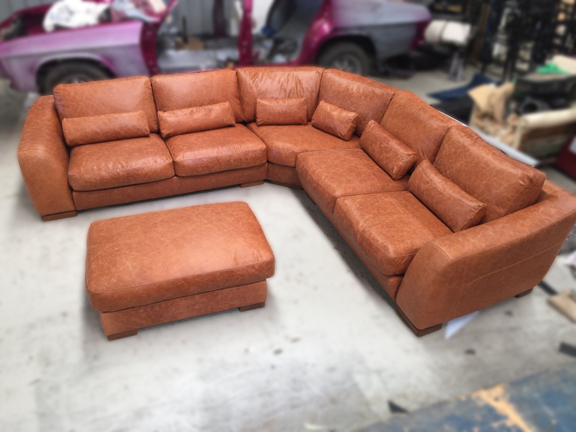 Brown leather corner lounge suite with ottoman