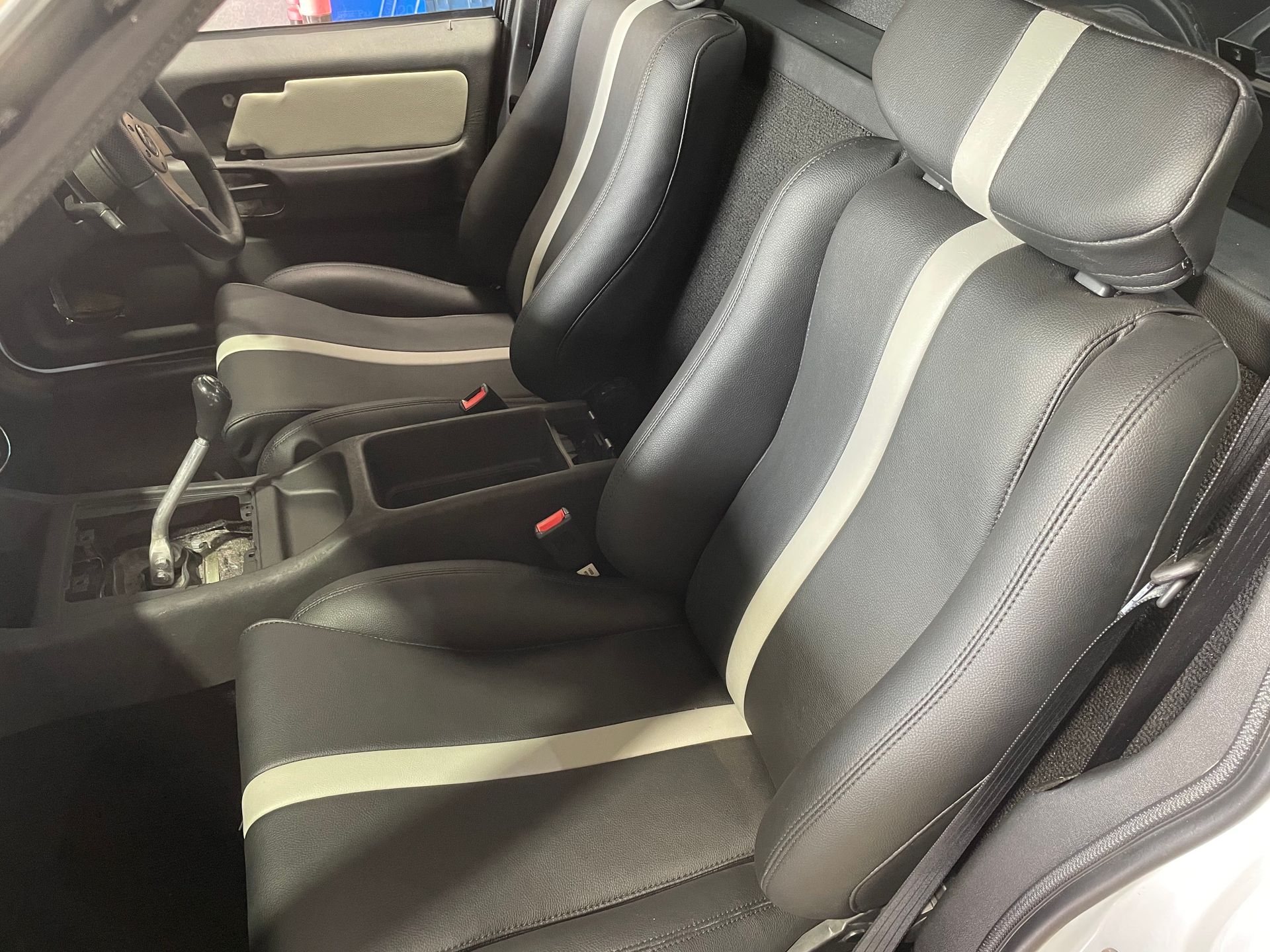 Bucket seats in custom black auto vinyl with cream stripe