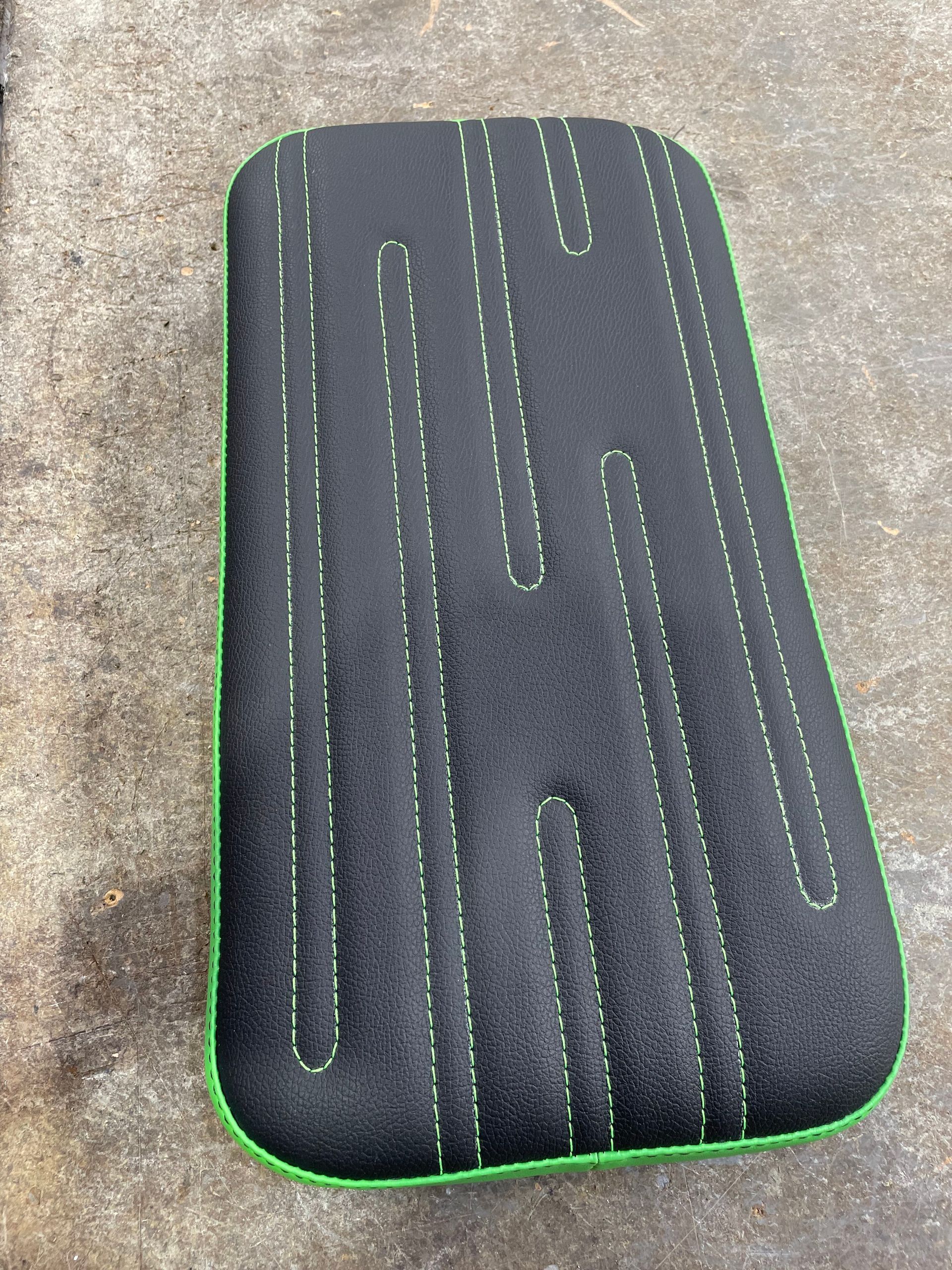 Custom designed padded cushion black and green vinyl with stitiching