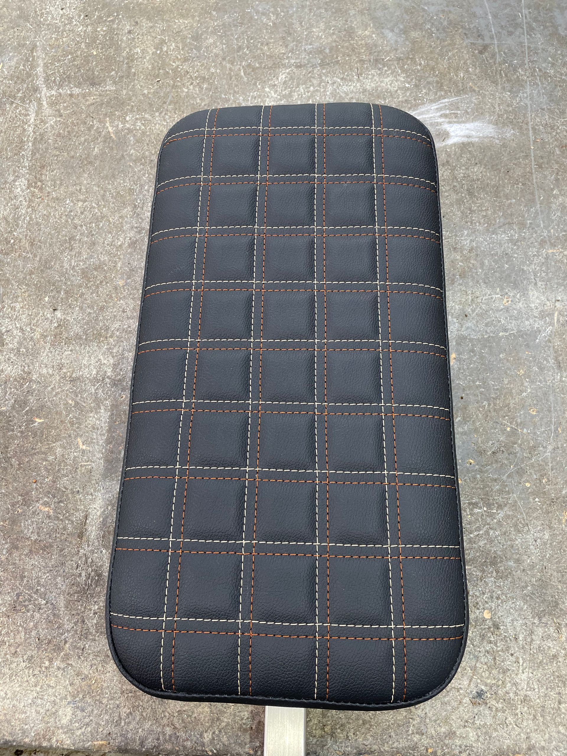 Custom designed padded cushion black vinyl square stitch