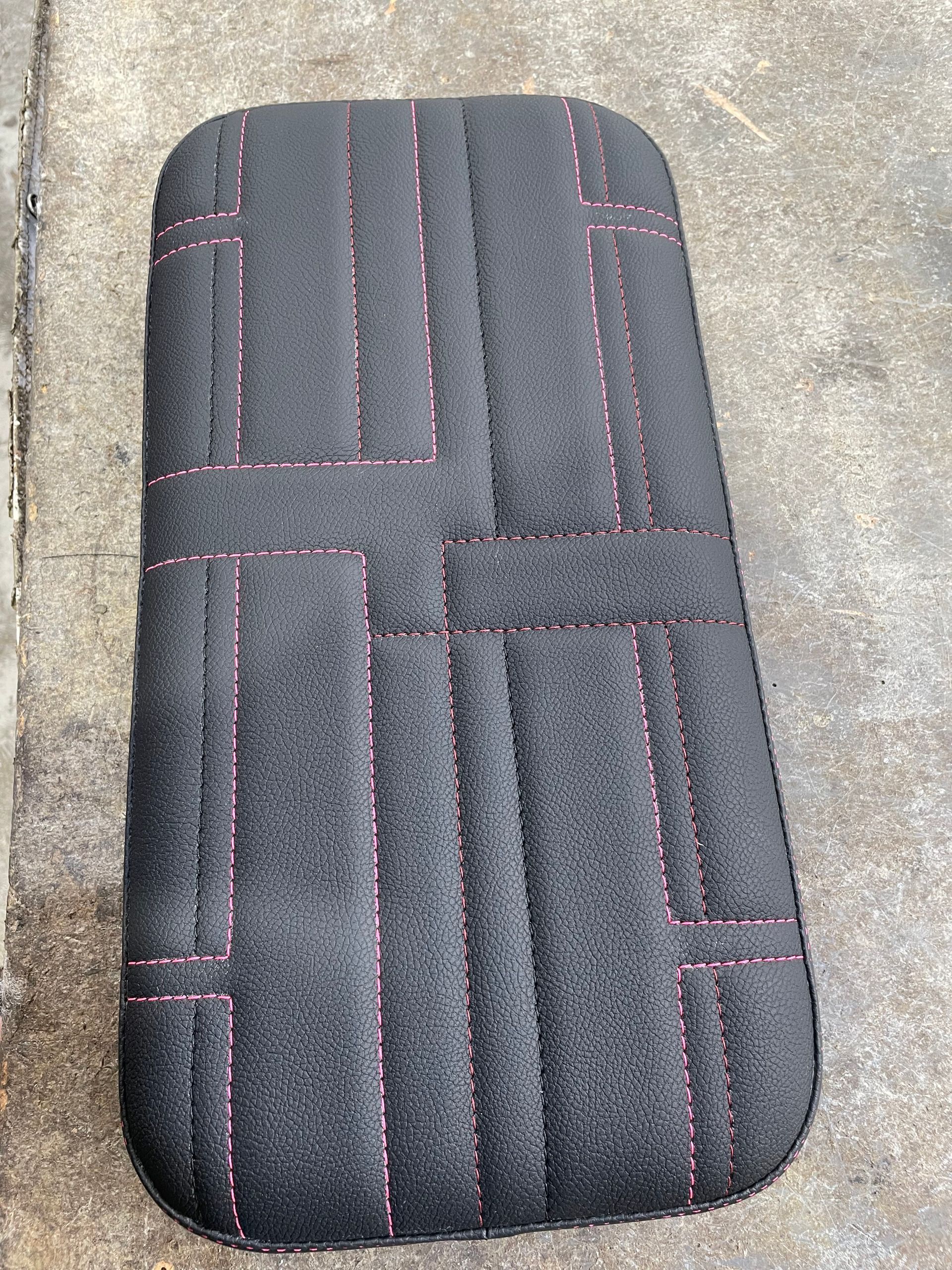Custom designed padded cushion black vinyl with pink stitching