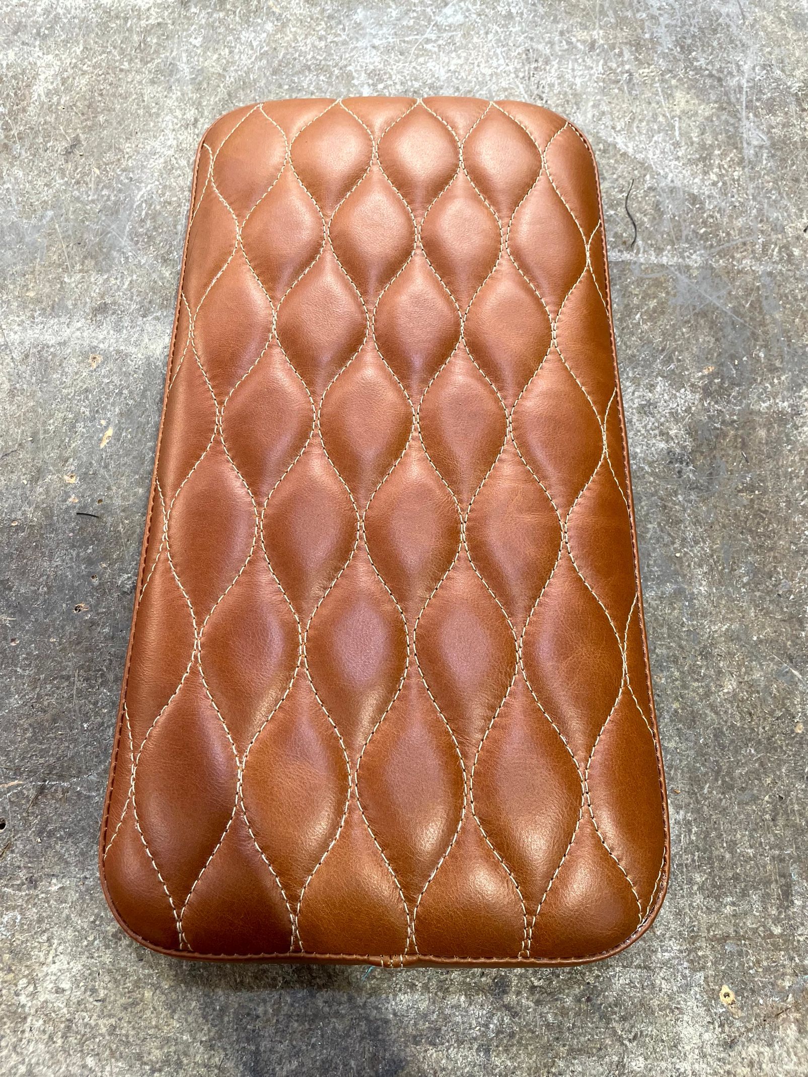 Custom designed padded cushion brown stitched leather