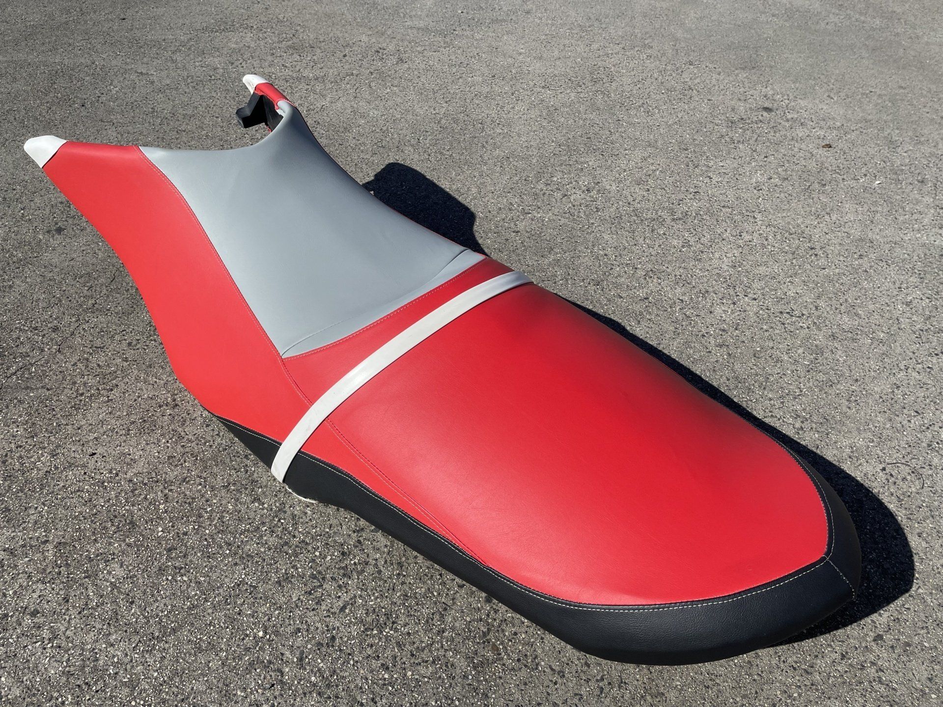 Jet ski seat refurb in red, black and grey marine vinyl