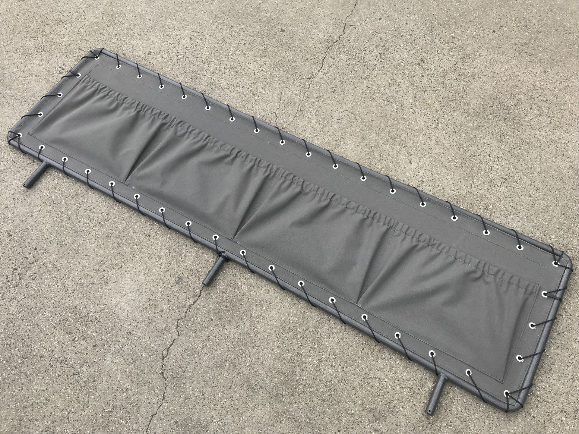 Canvas stoneguard with 4 storage pockets on tubular frame