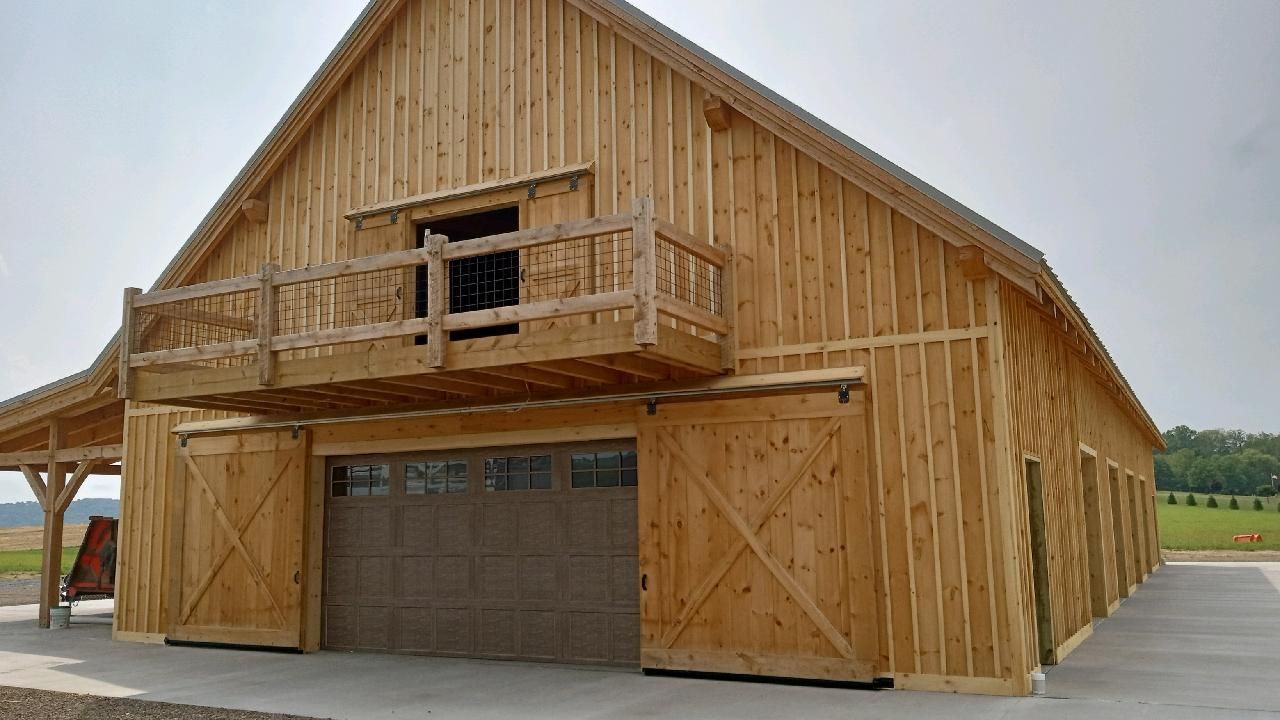A rustic handcrafted Amish wooden barn building by Central Timber Frame Supply.