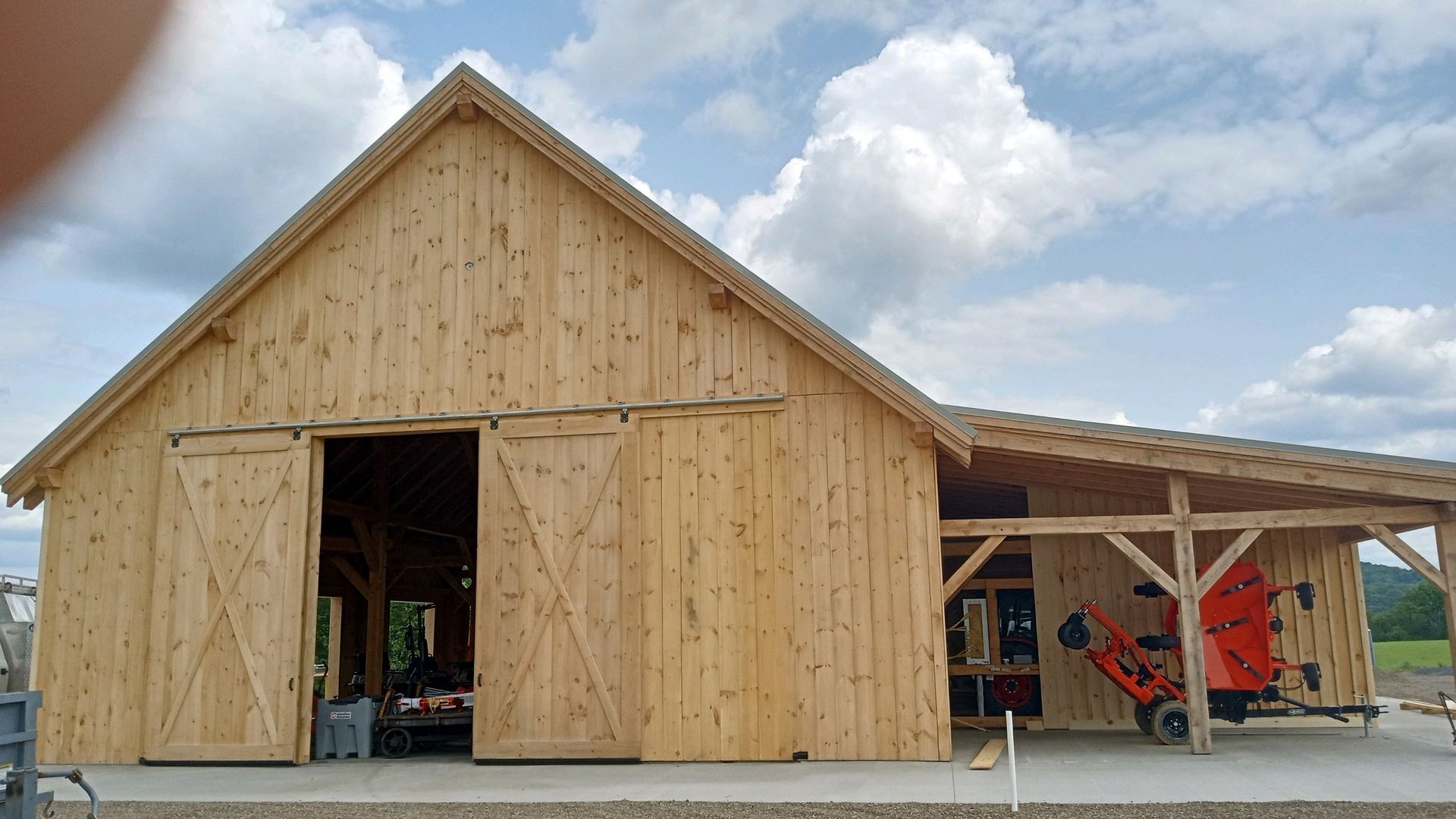 A newly constructed custom built wooden barn made by Central Timber Frame Supply. 
