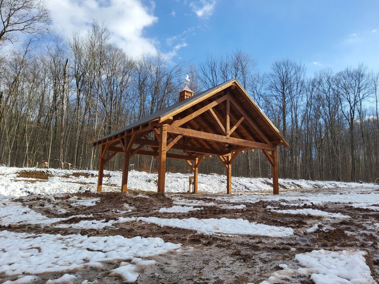 A wooden pavilion with a cupola by Central Timber Frame Supply available for wholesale across the United States 
