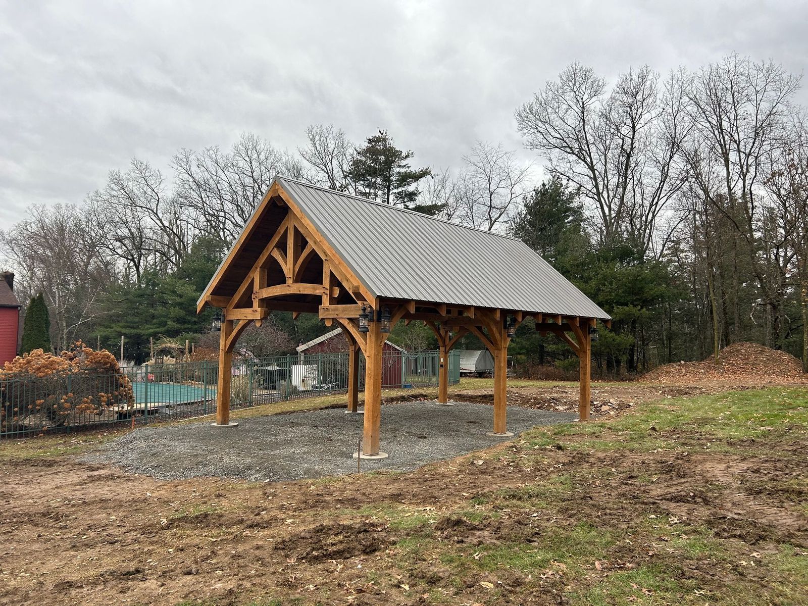 A timber-frame pavilion by Central Timber Frame Supply available for wholesale across the United States with a metal roof 