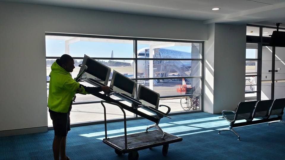 Worker in A Neon Jacket Maneuvering a Tilted Cart Inside a Bright — MM Removals In Nelson Bay, NSW