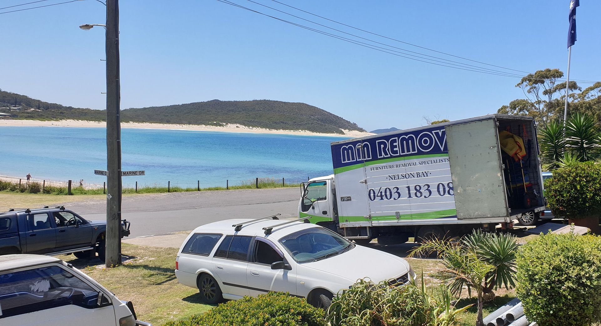 Blue Truck Parked by A Coastal Road — MM Removals In Lemon Tree Passage, NSW