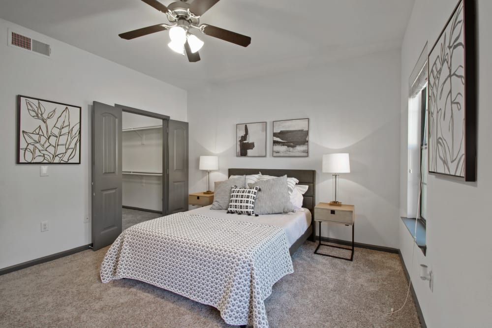 a bedroom with a large bed and a ceiling fan at Marquis on Evans in San Antonio, TX.