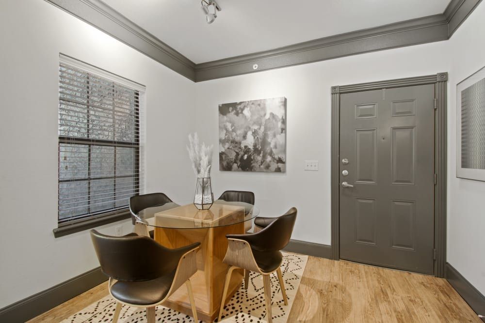 a dining room with a table and chairs and a painting on the wall at Marquis on Evans in San Antonio, TX.