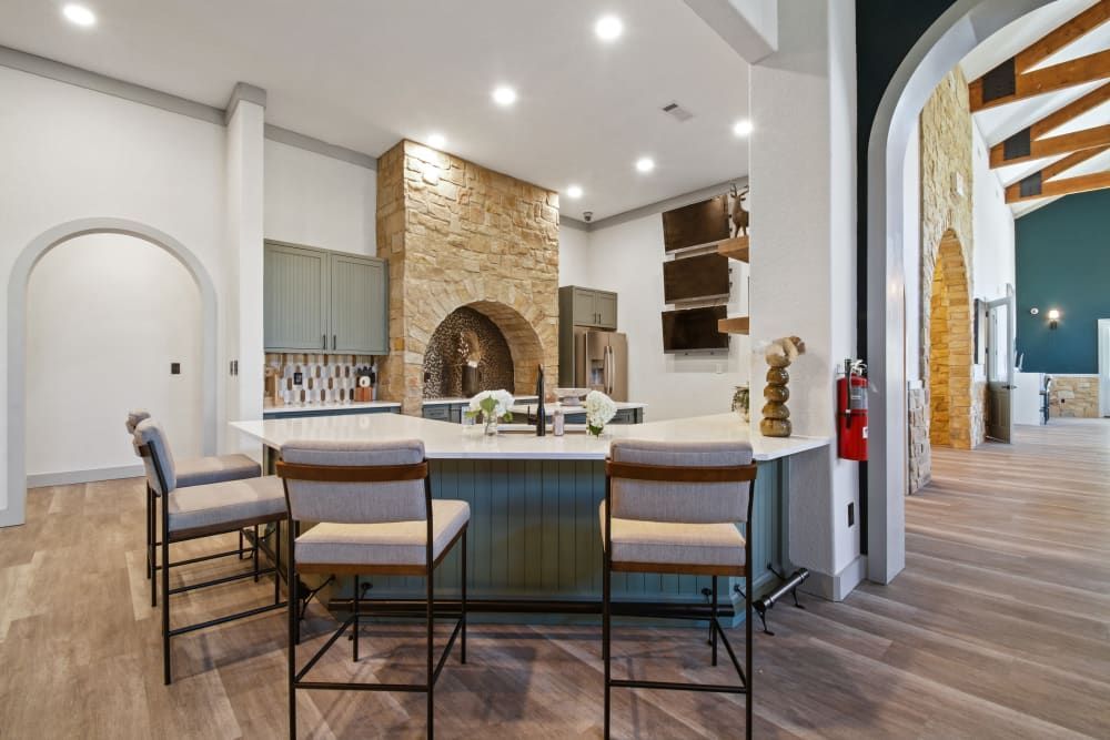 a kitchen with a large island and chairs in it at Marquis on Evans in San Antonio, TX.