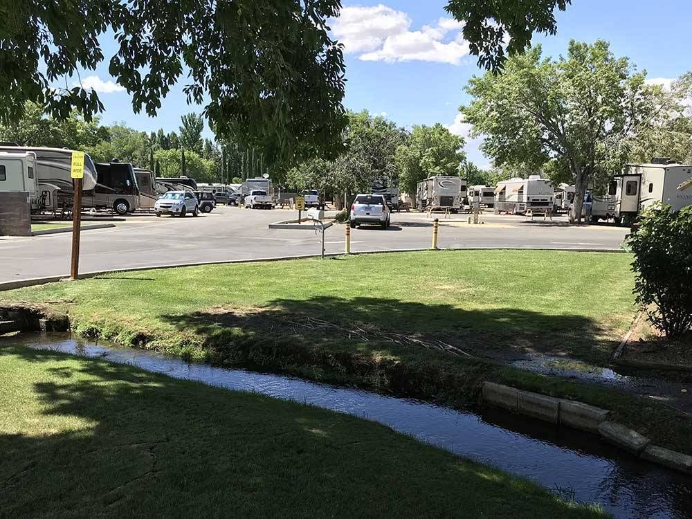 A rv park with a stream running through it