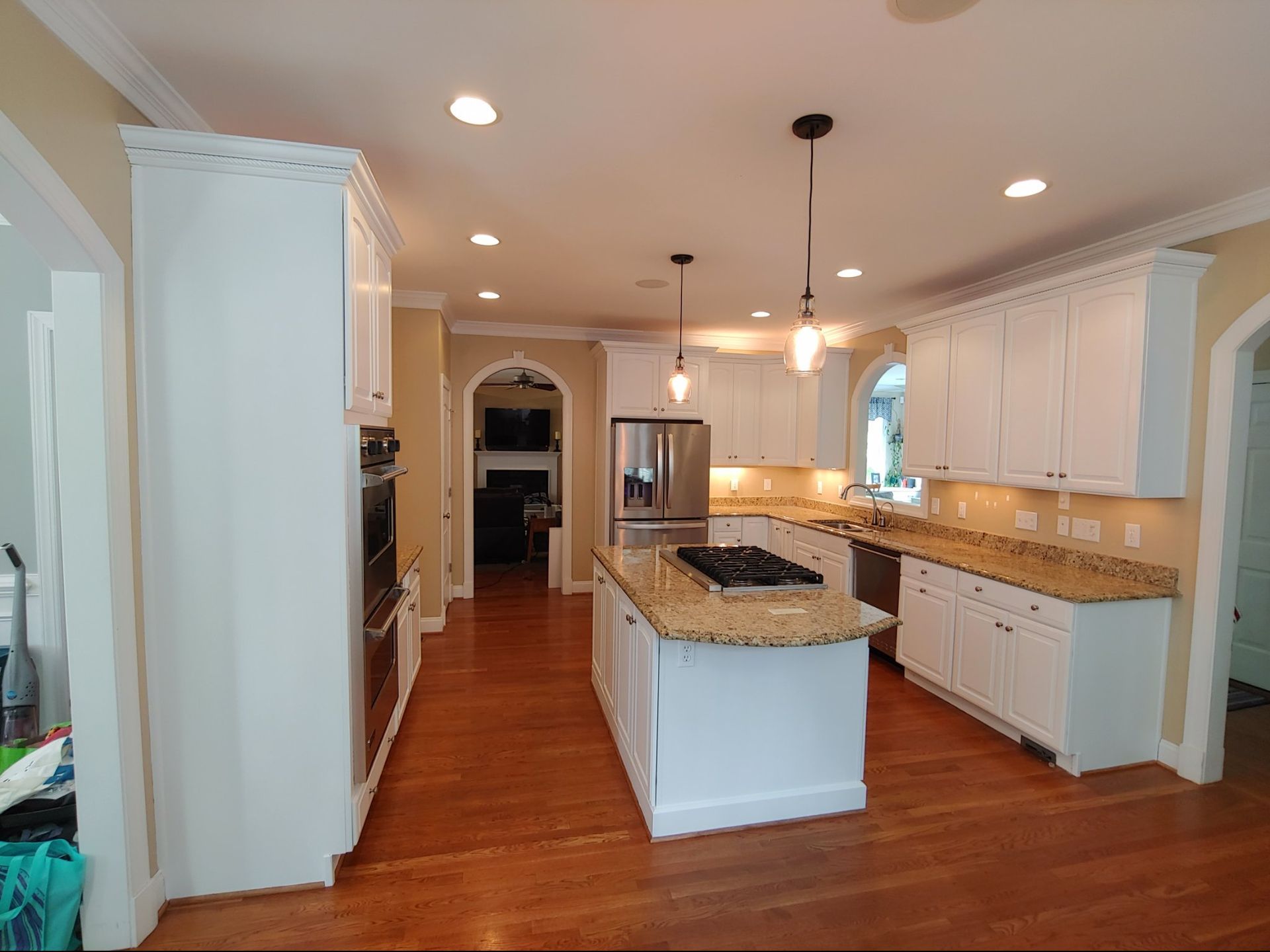A kitchen with white cabinets and granite counter tops