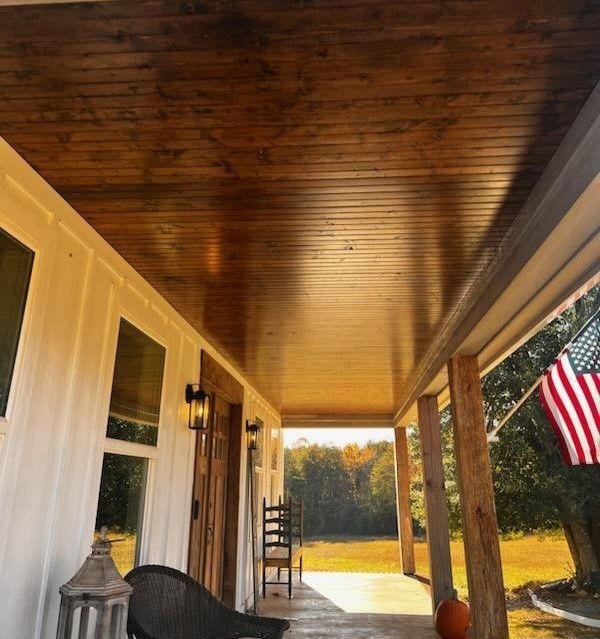 A porch with a chair and an american flag