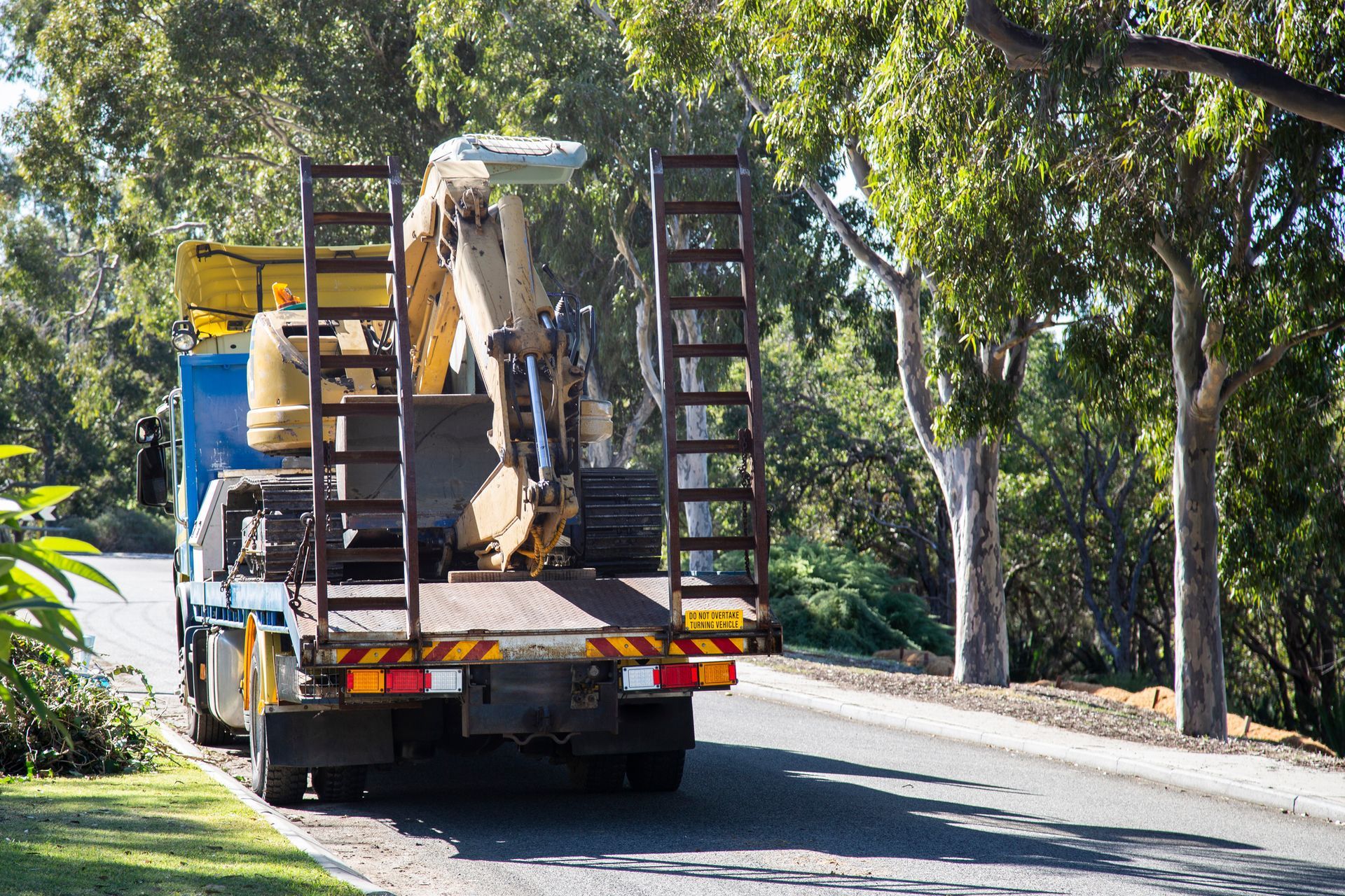 A large truck with a yellow sign on the back that says size.