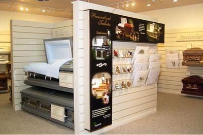 Mattress store display with a bed, shelving, and brochures in a bright showroom