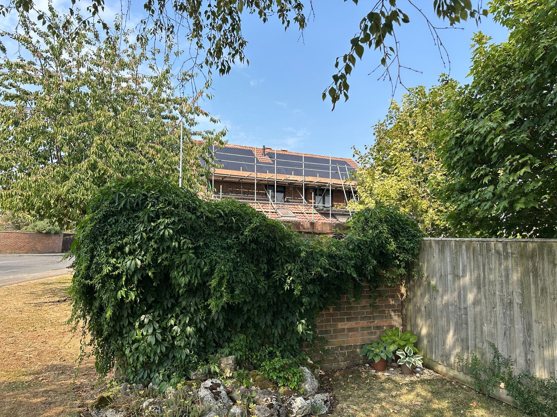 Close-up of solar panels mounted vertically on a tiled gable wall