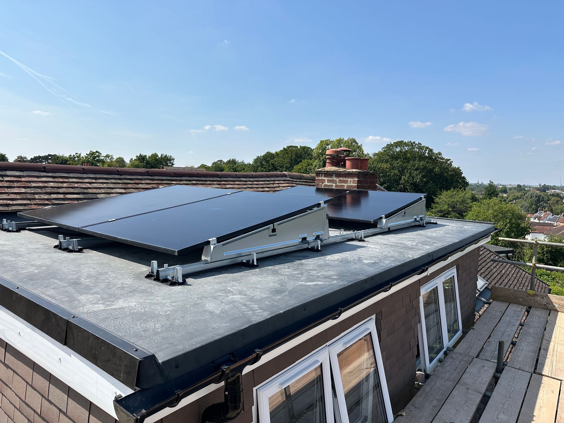 Close-up of solar panels mounted vertically on a tiled gable wall
