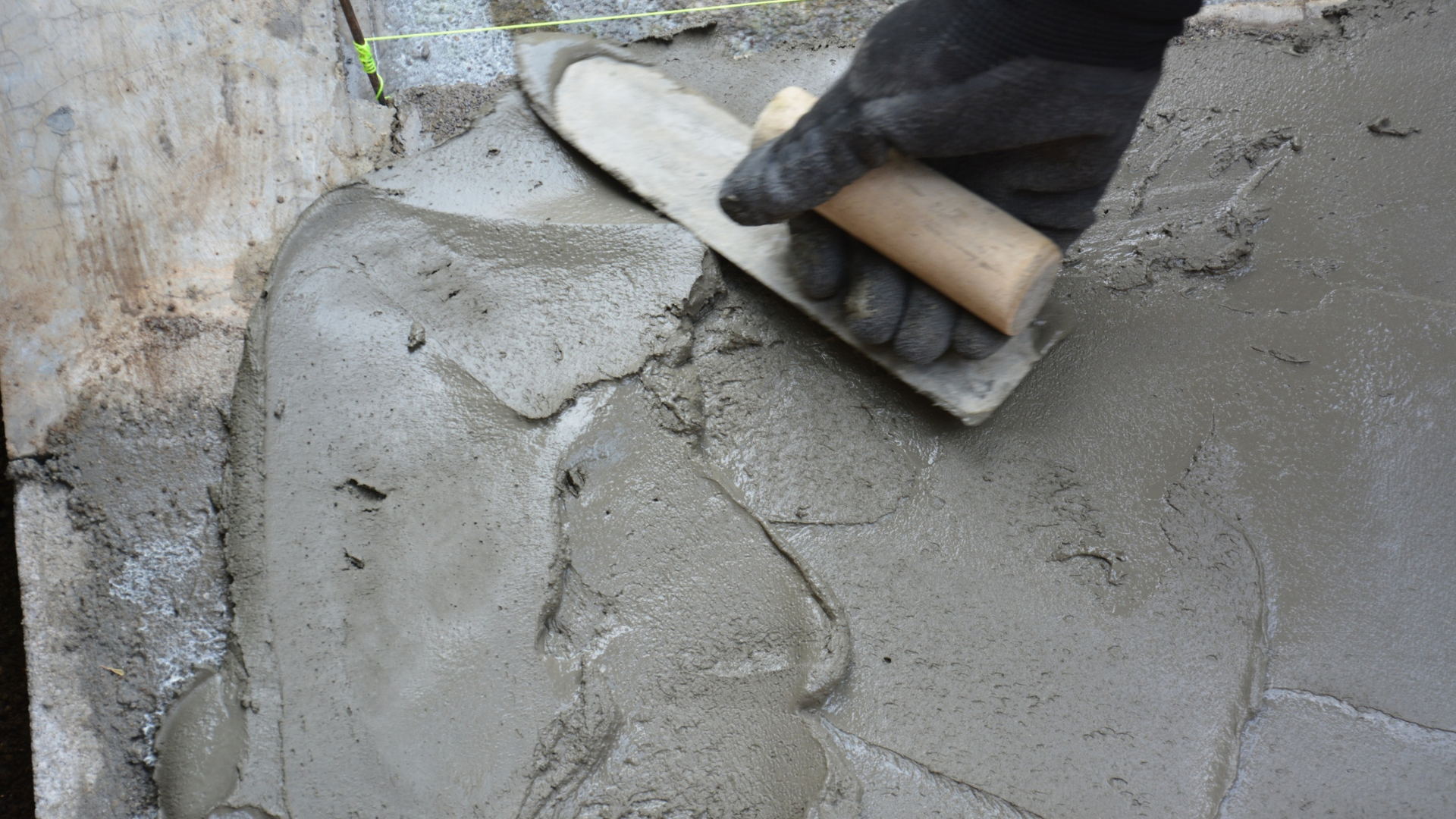 Concrete driveway installation crew preparing base layer in Smithtown NY