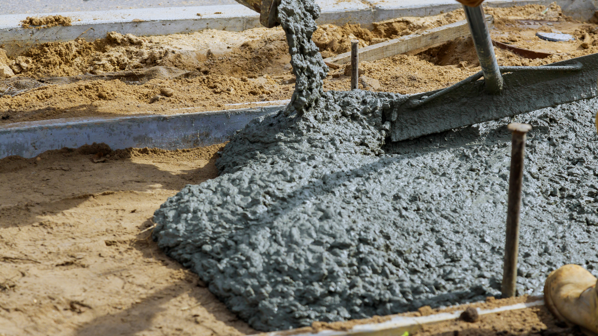 Heavy equipment preparing ground for new concrete slab installation