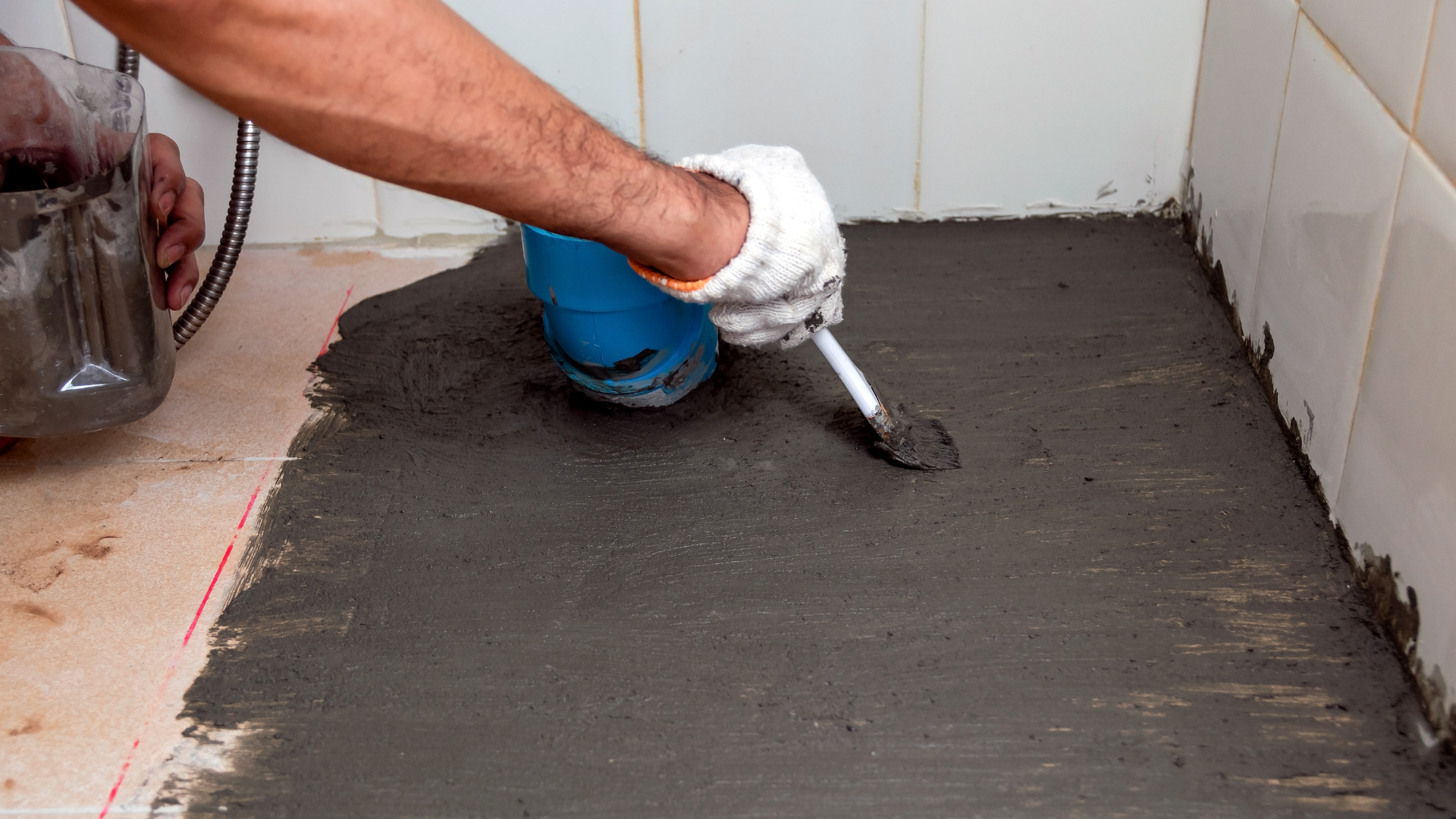 Concrete service team leveling driveway surface using professional screed tools