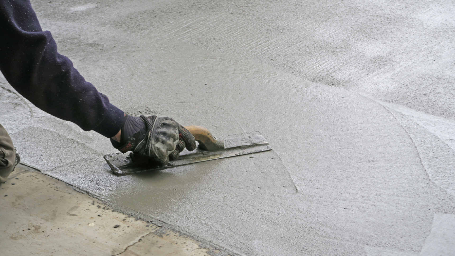 Concrete finishing team creating smooth durable driveway surface
