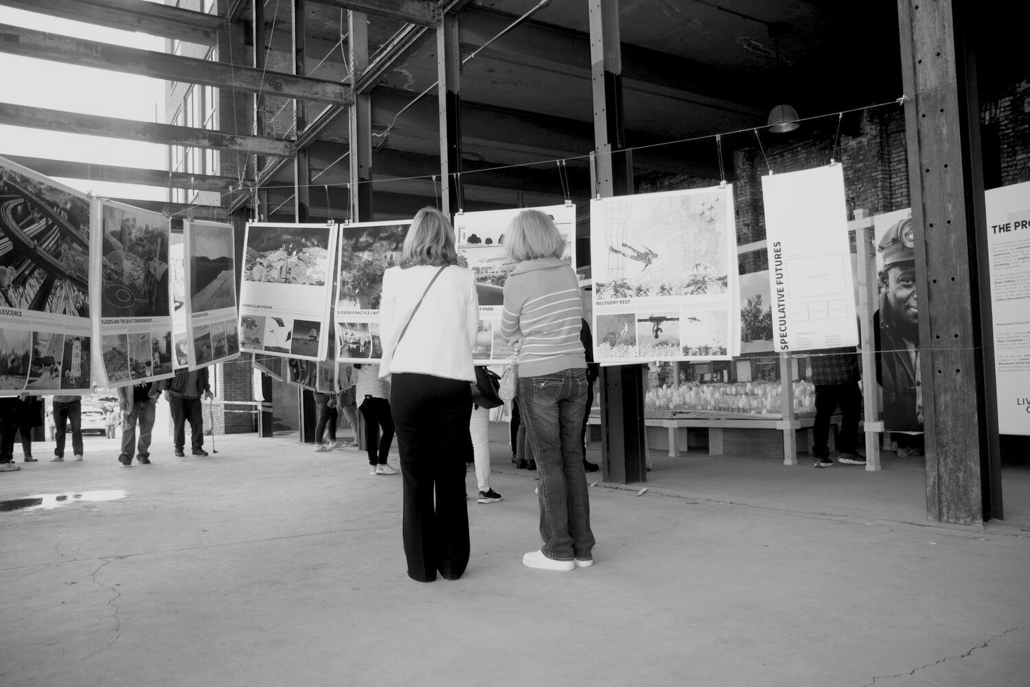 A black and white photo of people walking in a city