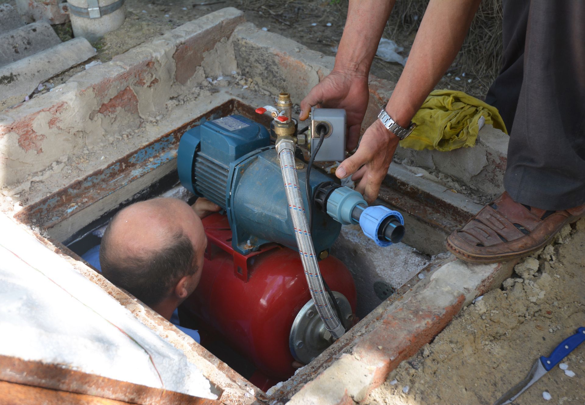 Contractors installing and repair water pump station.