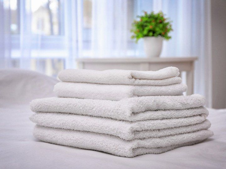 beach towels stacked on a bed