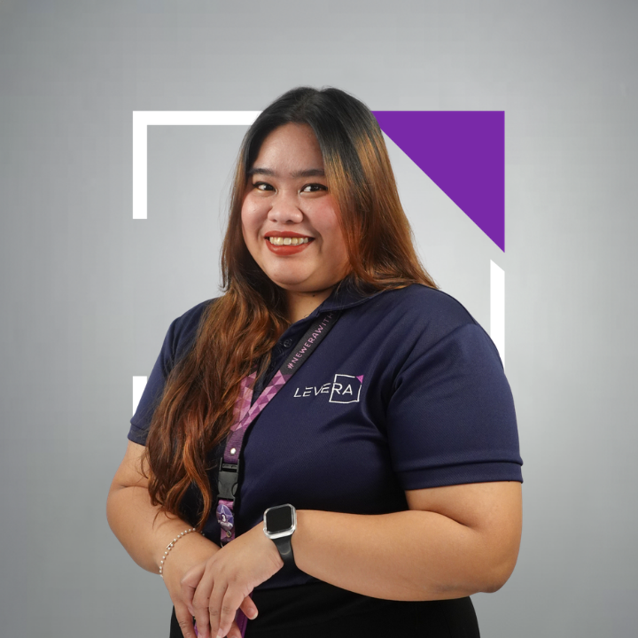 A woman wearing a purple shirt that says levera