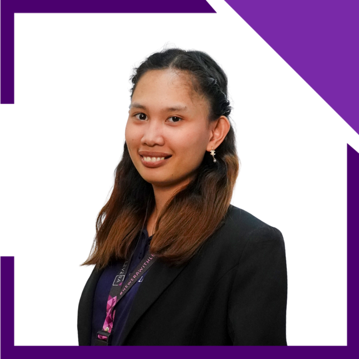 A woman wearing a purple shirt and a black jacket