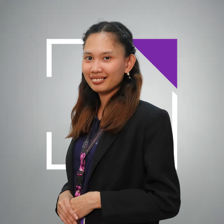 A woman in a purple shirt with her arms crossed