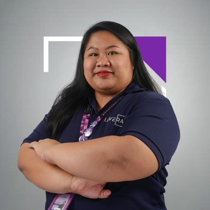 A woman wearing a purple shirt that says levera