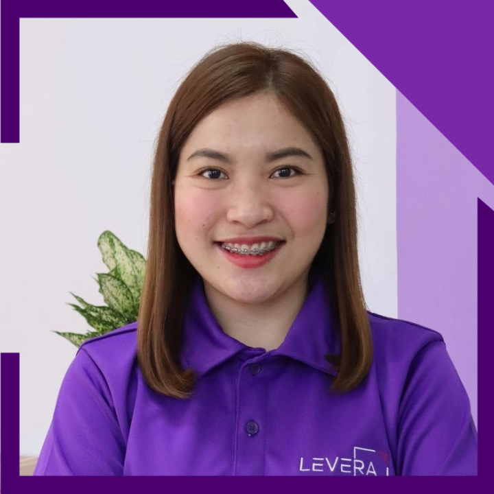 A woman wearing a purple shirt that says levera