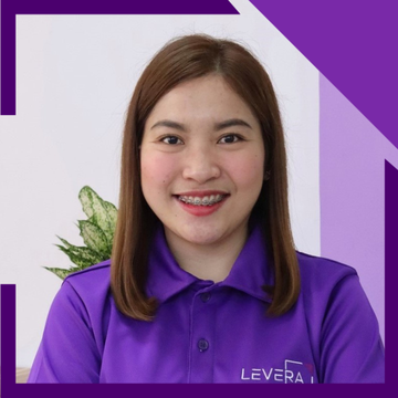 A woman wearing a purple shirt that says levera