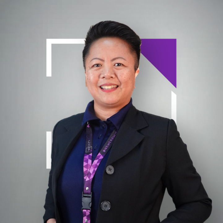 A man wearing a purple shirt that says levera